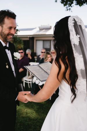 Wedding ceremony sequence showing a couple reading their vows and sharing emotional moments together.