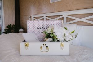 White decorative elements and floral arrangements create an elegant wedding day setting.