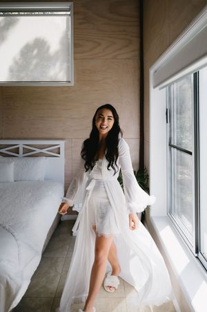 A series of ethereal bridal boudoir photos showing flowing white fabric and natural window light in an intimate setting.