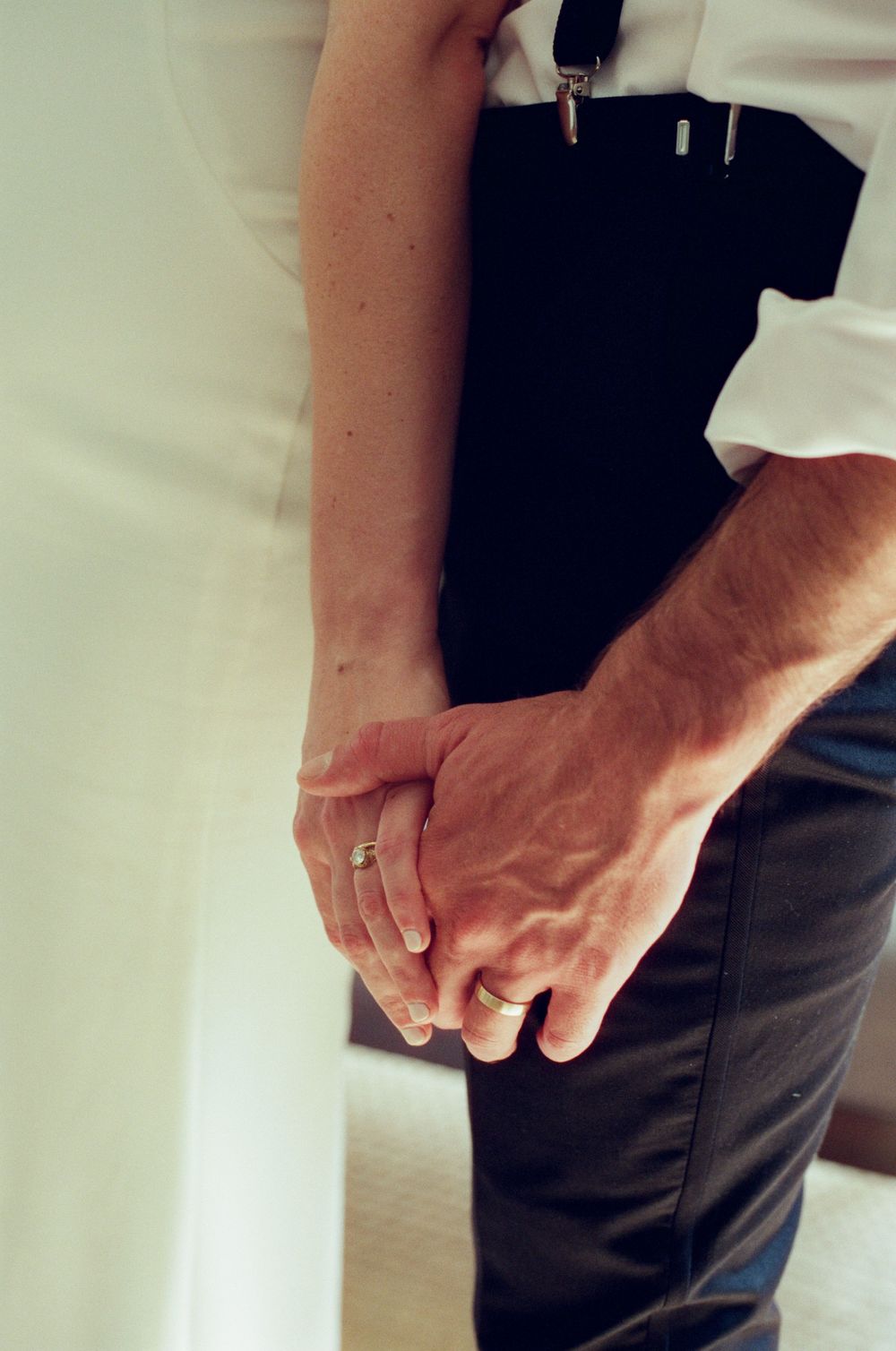 Close-up sequence of hands nervously fidgeting in pockets showing wedding day anticipation.