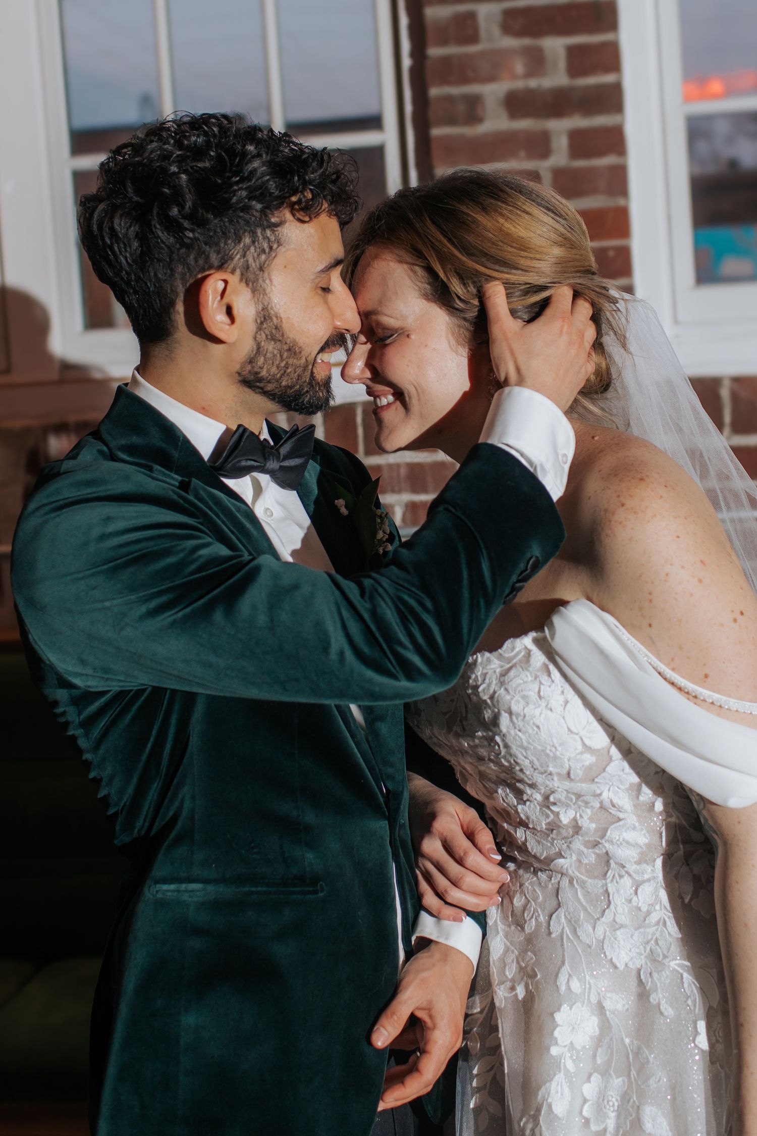 A romantic wedding moment captured in a series of intimate poses showing the couple in formal attire against a brick wall.