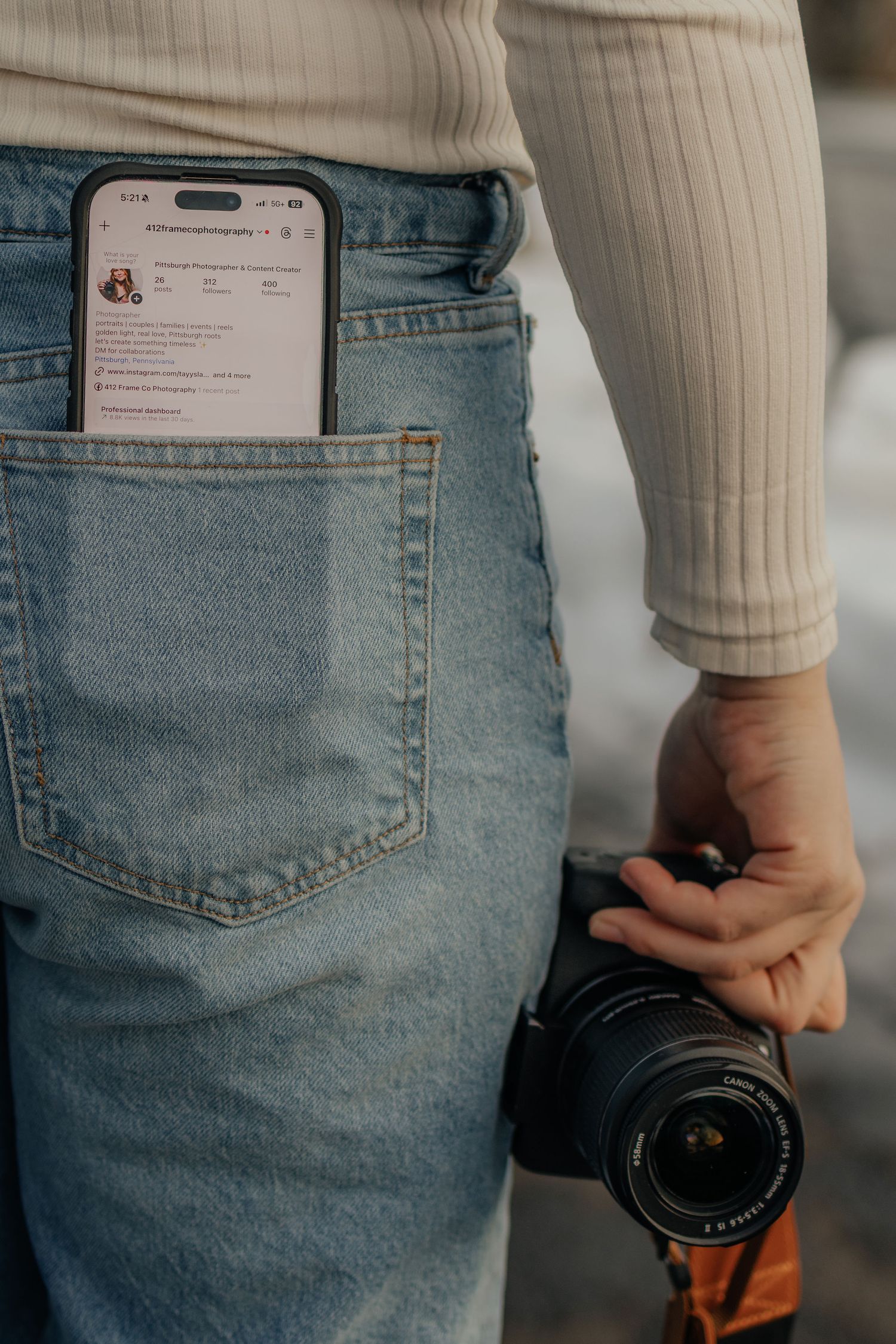 Close-up shots of someone wearing jeans and holding a camera lens.