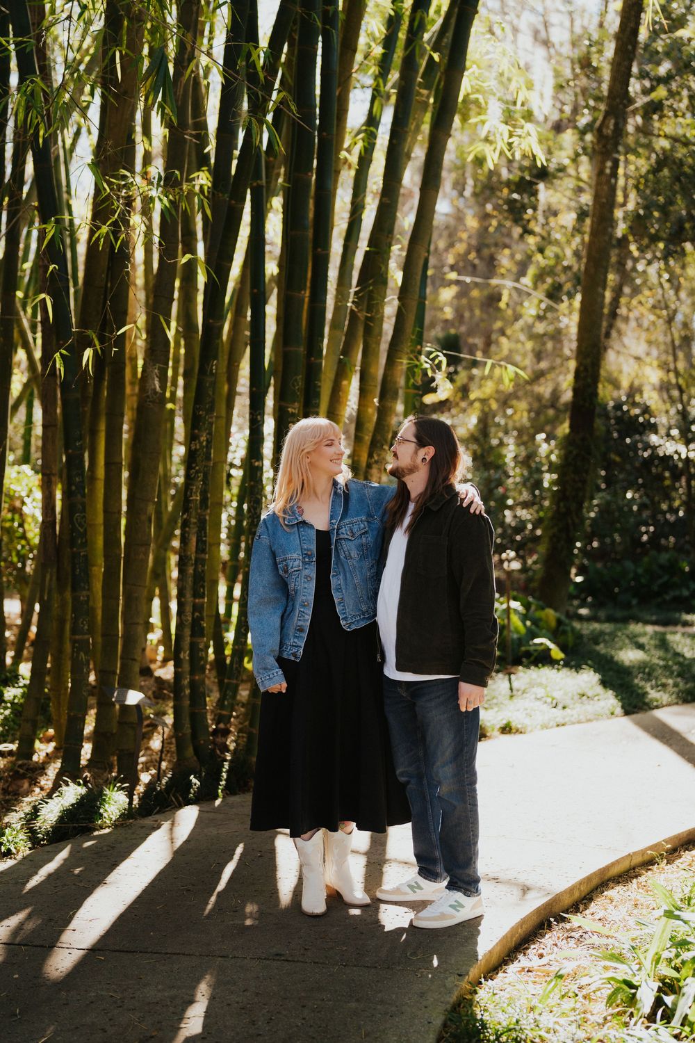 A couple shares intimate moments in a sunlit bamboo forest, creating a romantic outdoor photoshoot sequence.
