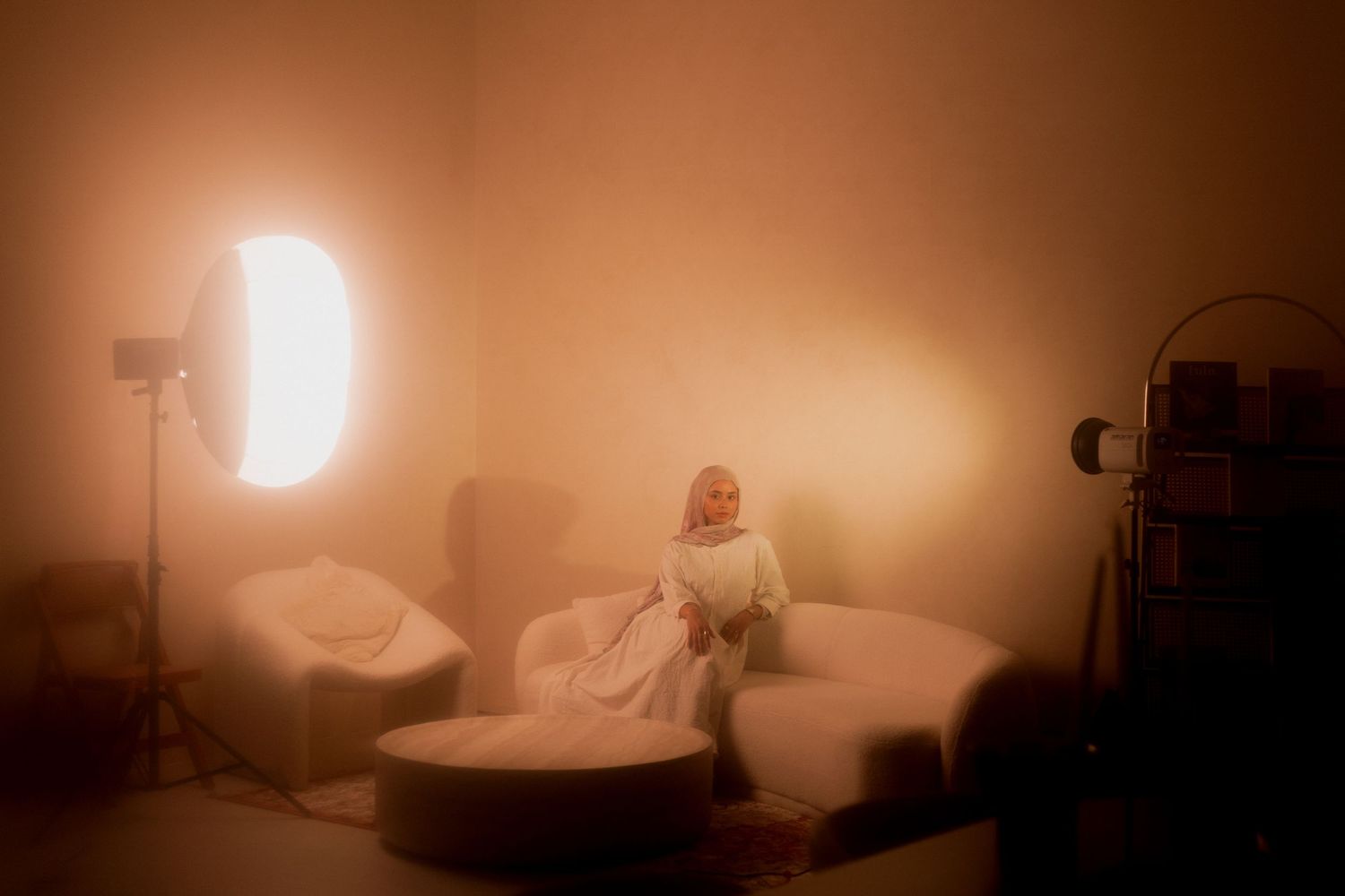A series of minimalist photographs showing people sitting in white and beige spaces arranged in a horizontal sequence.
