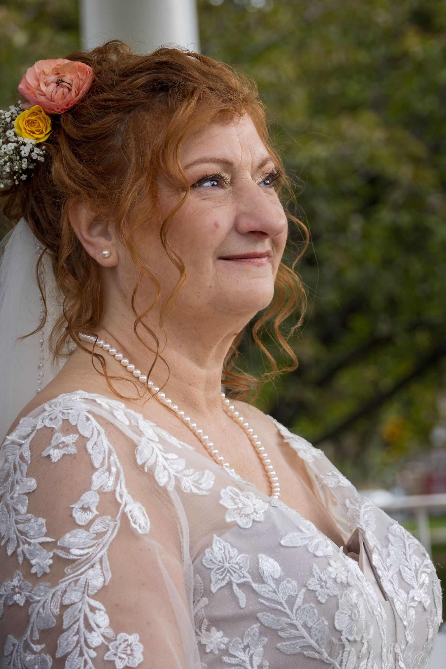 frederick maryland wedding photographer Close-up of a lace wedding dress with delicate floral embroidery and sheer details.