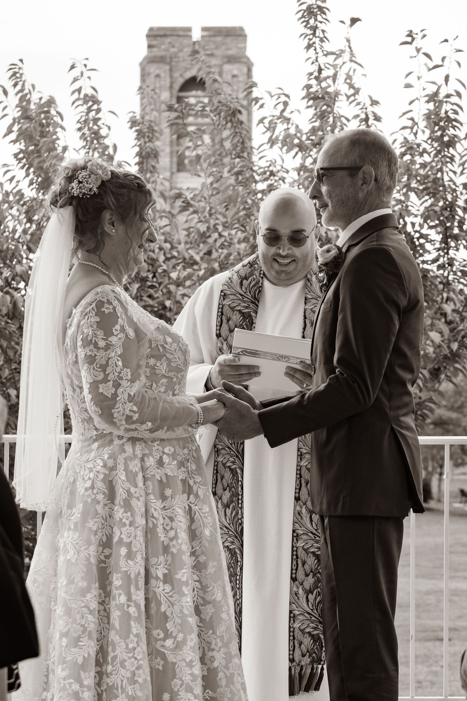frederick maryland wedding photographer Wedding ceremony participants standing near white columns during outdoor service.