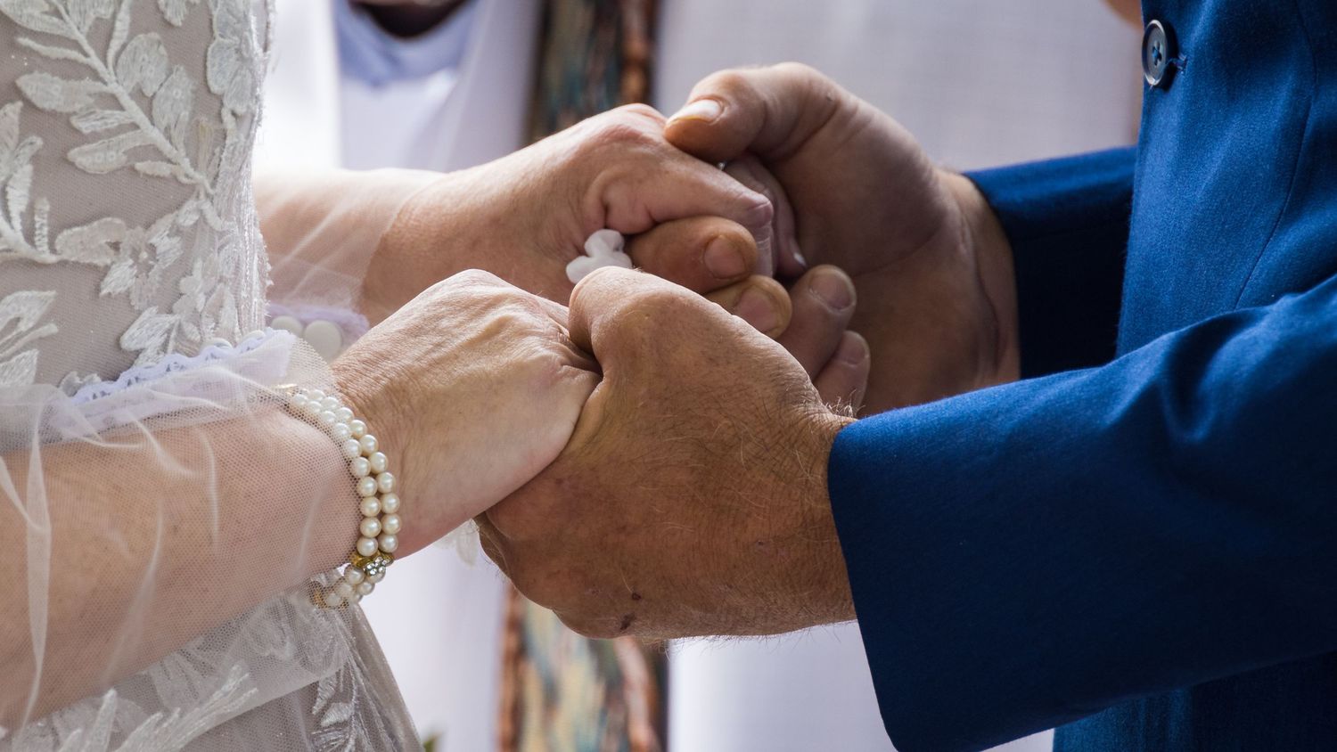frederick maryland wedding photographer Close-up of hands during wedding ring exchange ceremony.
