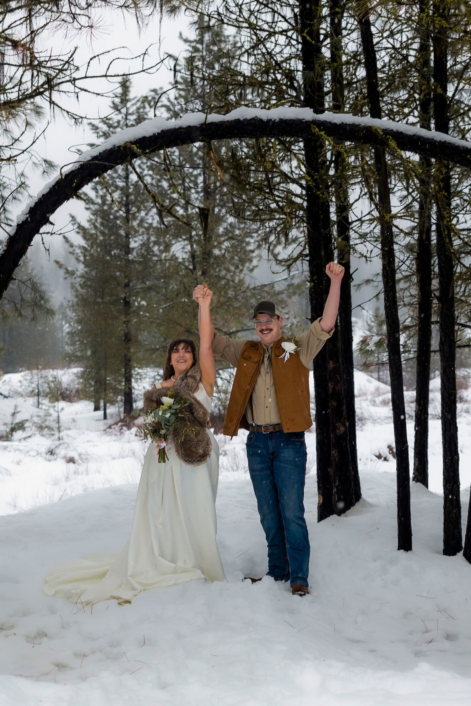Snowy elopement bride and groom celebrating after saying I Do