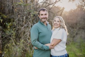 Family portrait session at sunset in rustic outdoor setting.