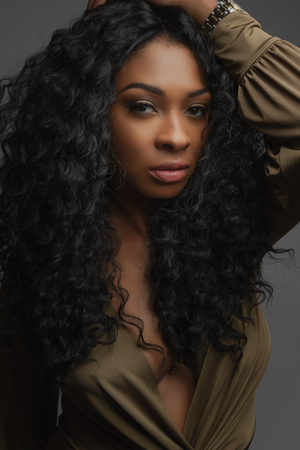 Portrait series featuring dramatic lighting and flowing curly black hair.