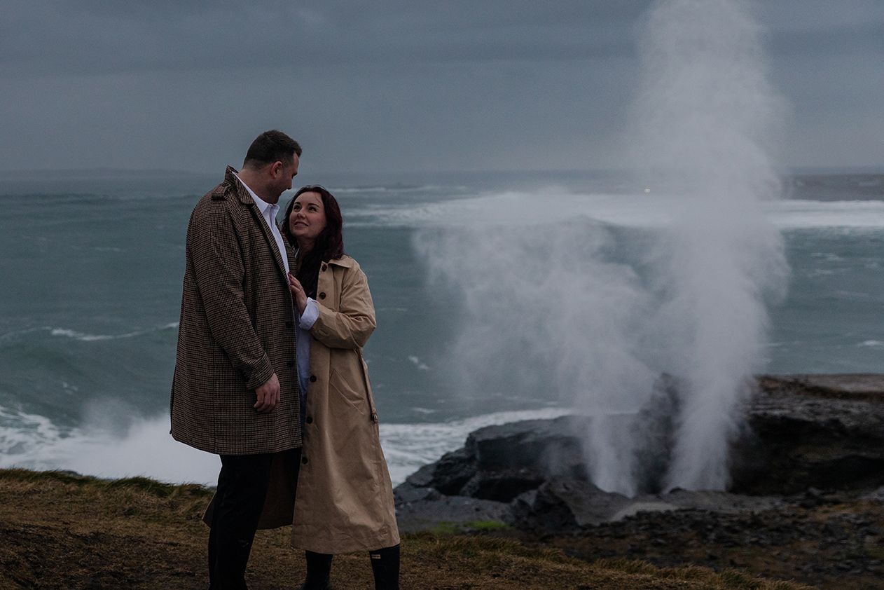 Destination engagement session at Doolin Cliff Walk with stormy sunset and Atlantic waves in Ireland