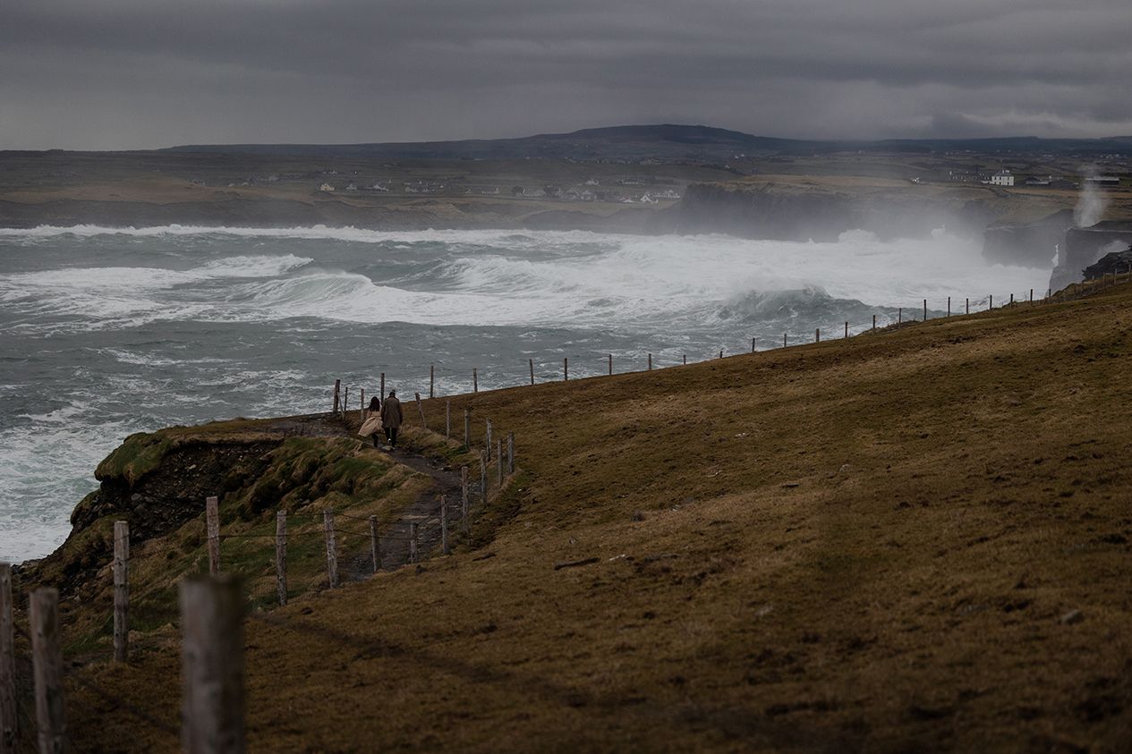 Stormy Atlantic waves hitting cliffs during sunset engagement session in County Clare Ireland
