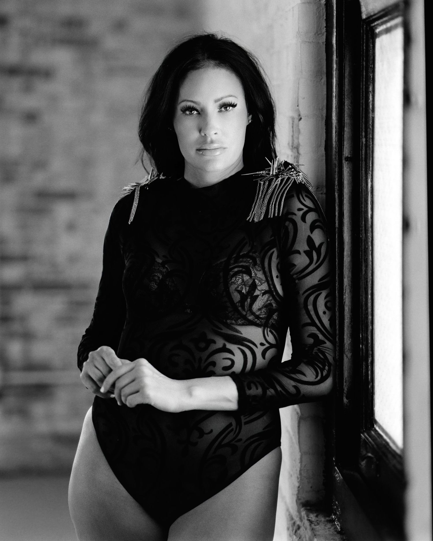David G Holt Photography - Dramatic portrait series against brick wall with moody lighting and black lace details.