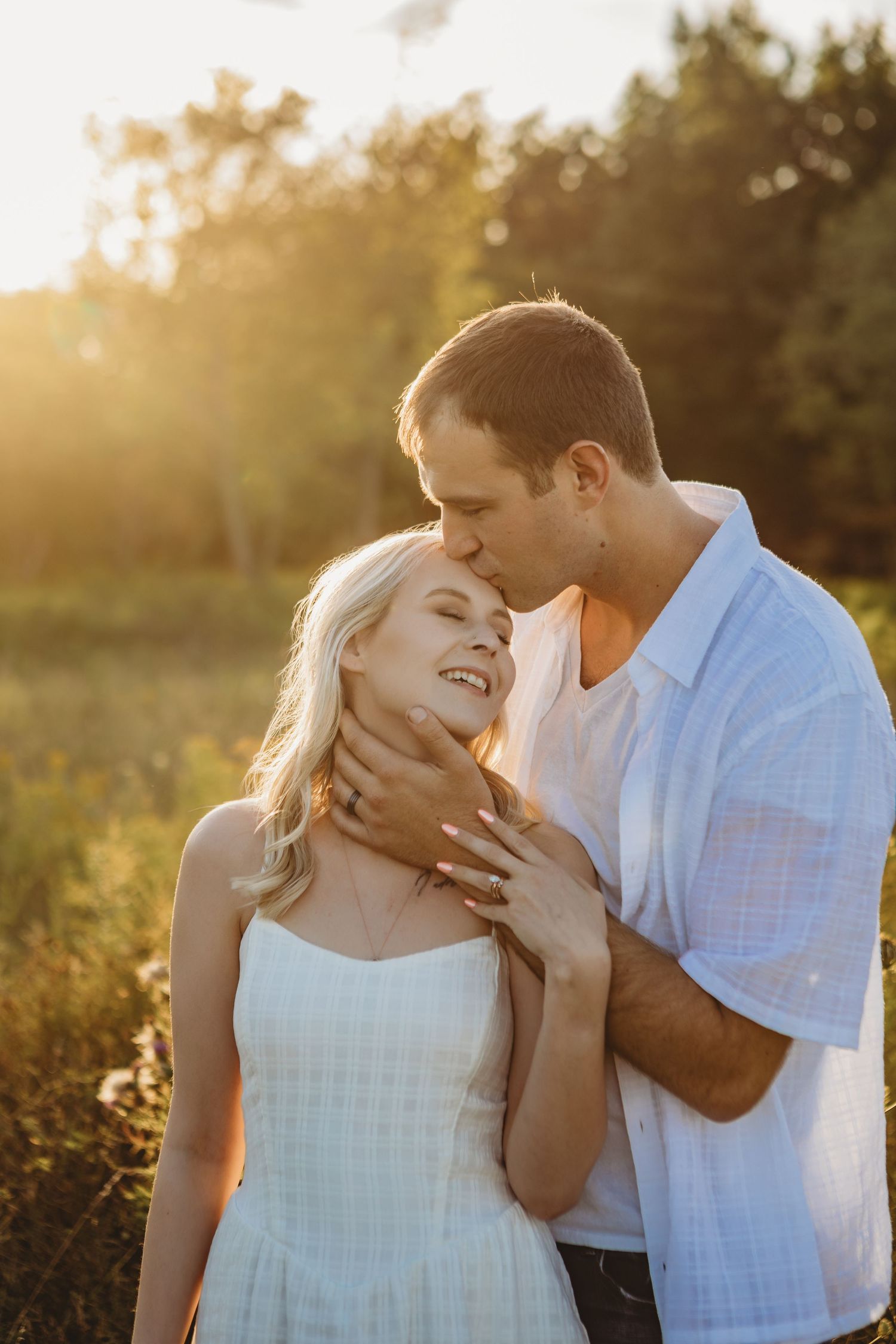 Intimate couple portrait session in golden sunlight showing tender moments.