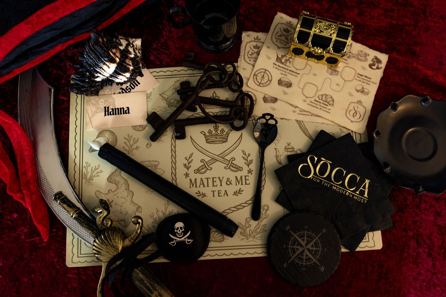 Dark and moody collection of vintage items including a gun, playing cards, and old letters arranged in film noir style.