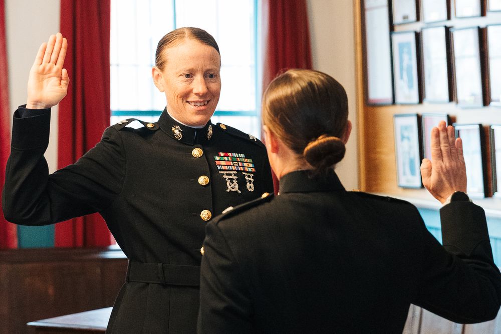 Military Promotion Ceremony with right hand in the air reciting the commitment speech.