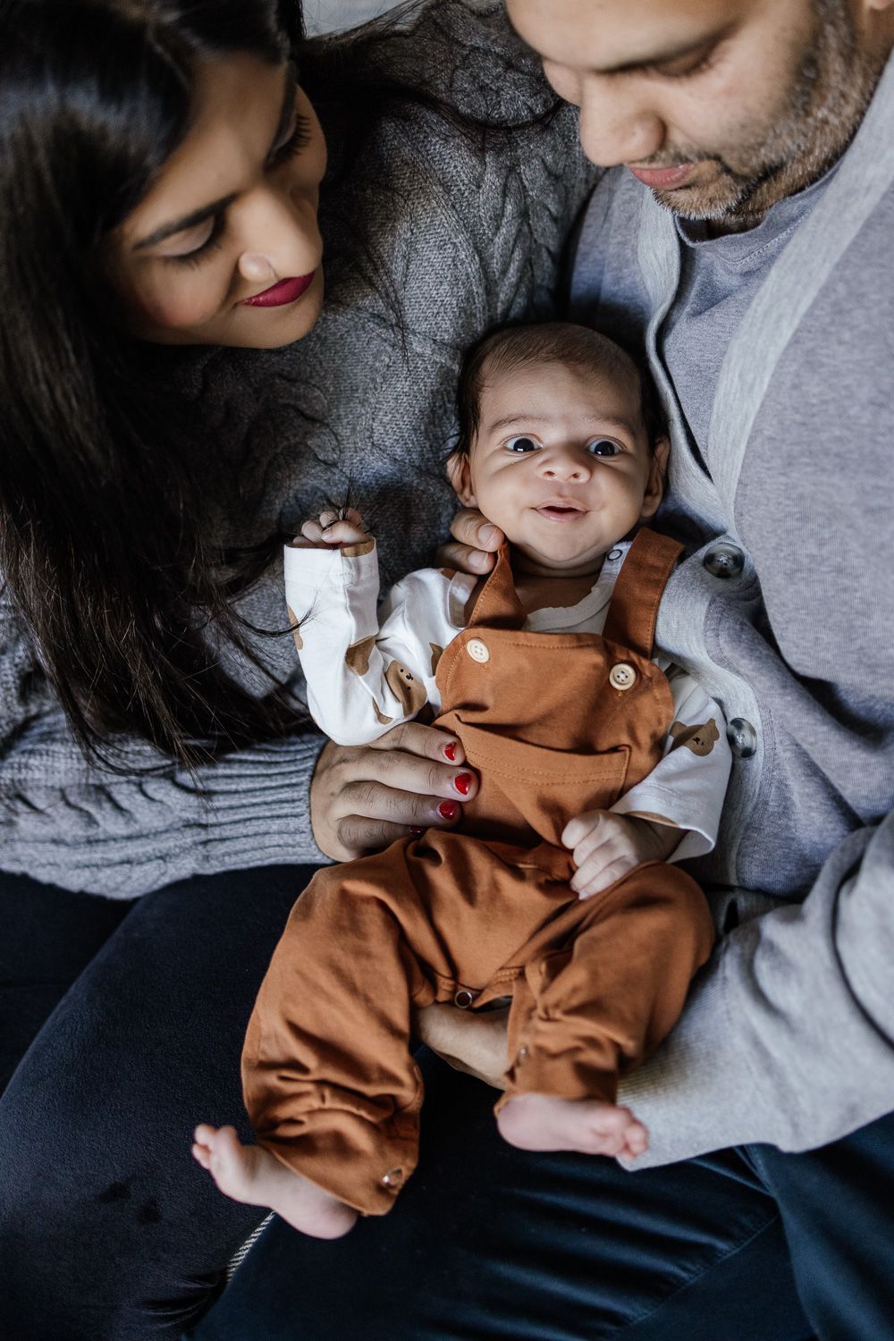 Baby smiles for camera during lifestyle newborn photos in San Jose