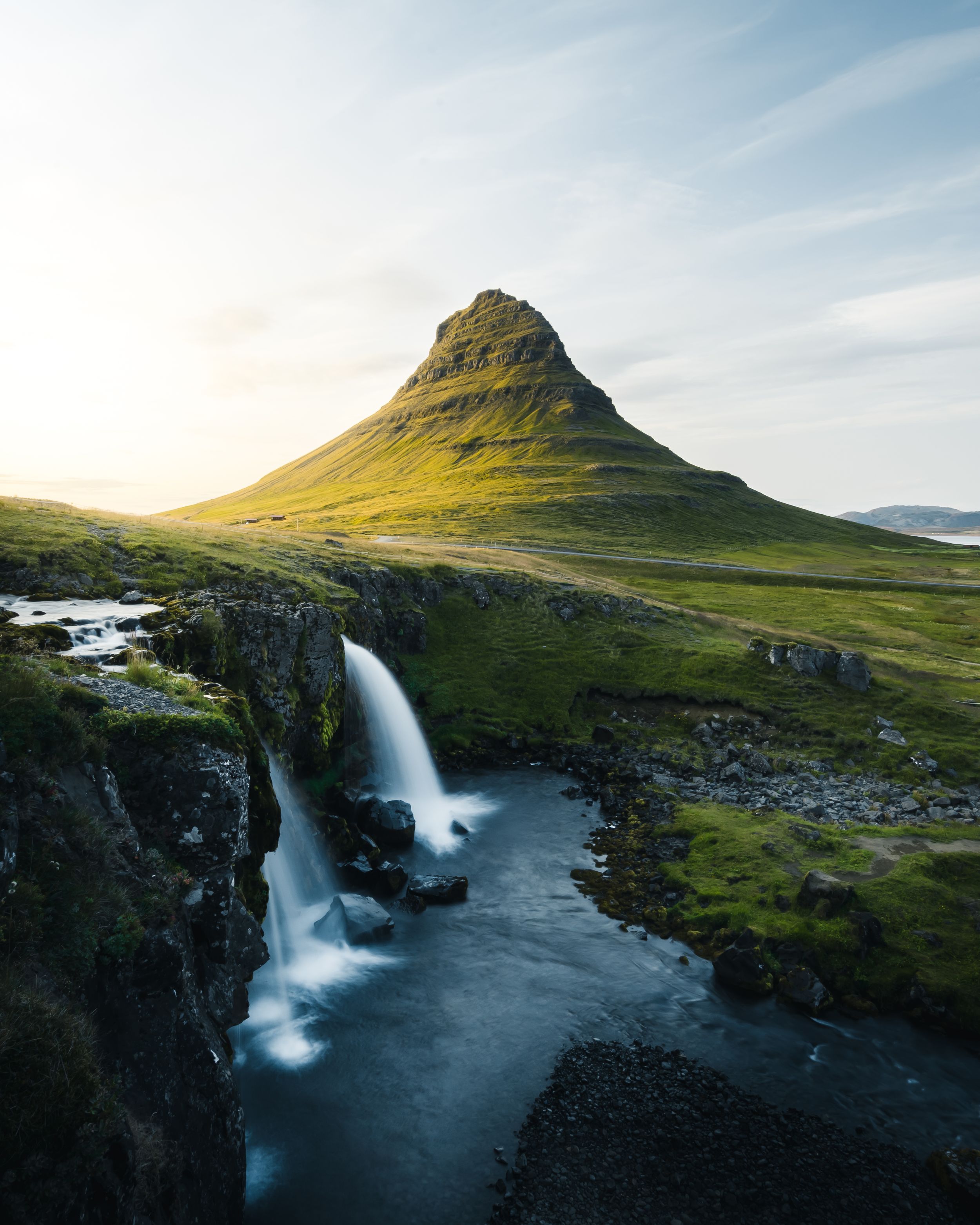 Panoramic view of Kirkjufell mountain with cascading waterfall in Iceland.