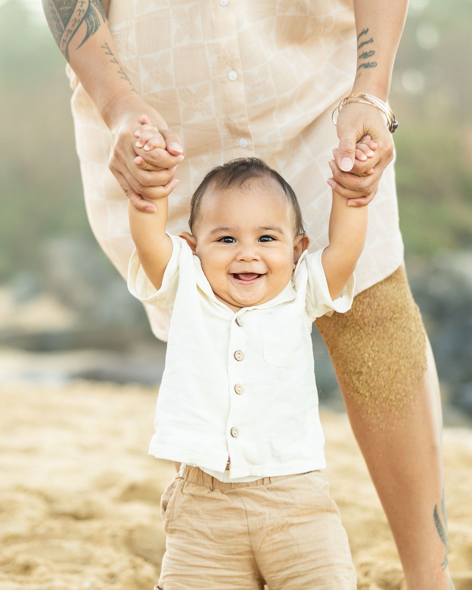 Mother walks smiling baby hand in hand during Wailea family photo session