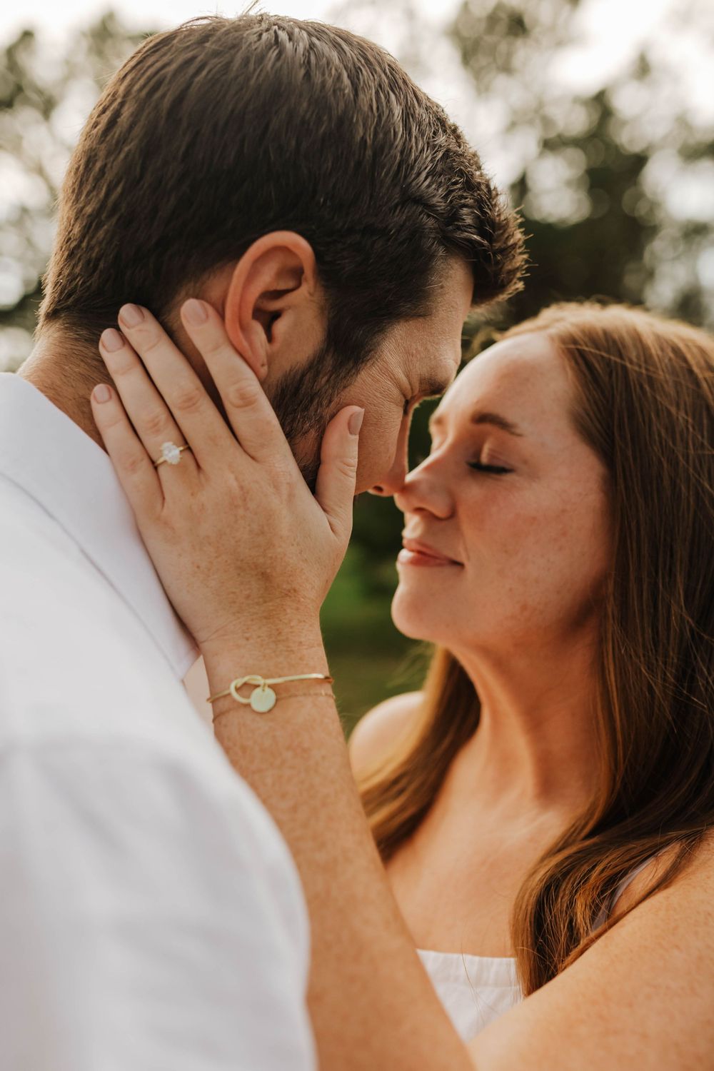 Close-up shots capture tender romantic moments between a couple against a soft natural background.
