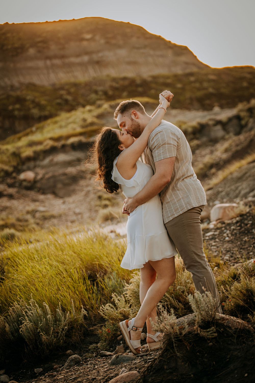 A romantic dance pose captured during a sunset photoshoot in the mountains.