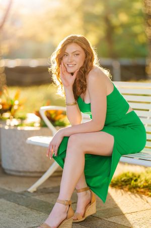 Outdoor portraits in golden sunlight featuring someone in an emerald green dress.