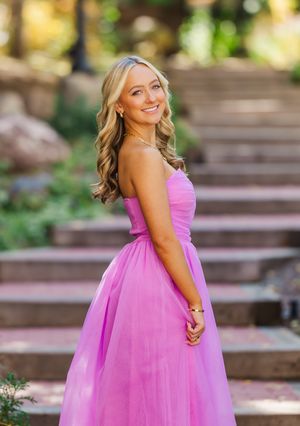A series of outdoor portraits featuring someone in a flowing pink tulle dress on wooden steps.