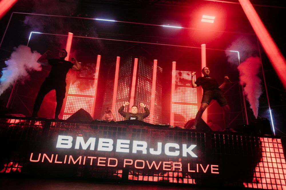 Stage display showing 'BMBERJCK' and 'UNLIMITED POWER LIVE' text in red illumination.