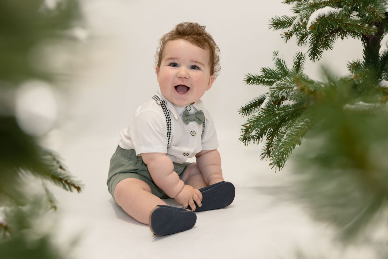 Photo de bébé pour Noël en studio avec décor lumineux et ambiance cocooning