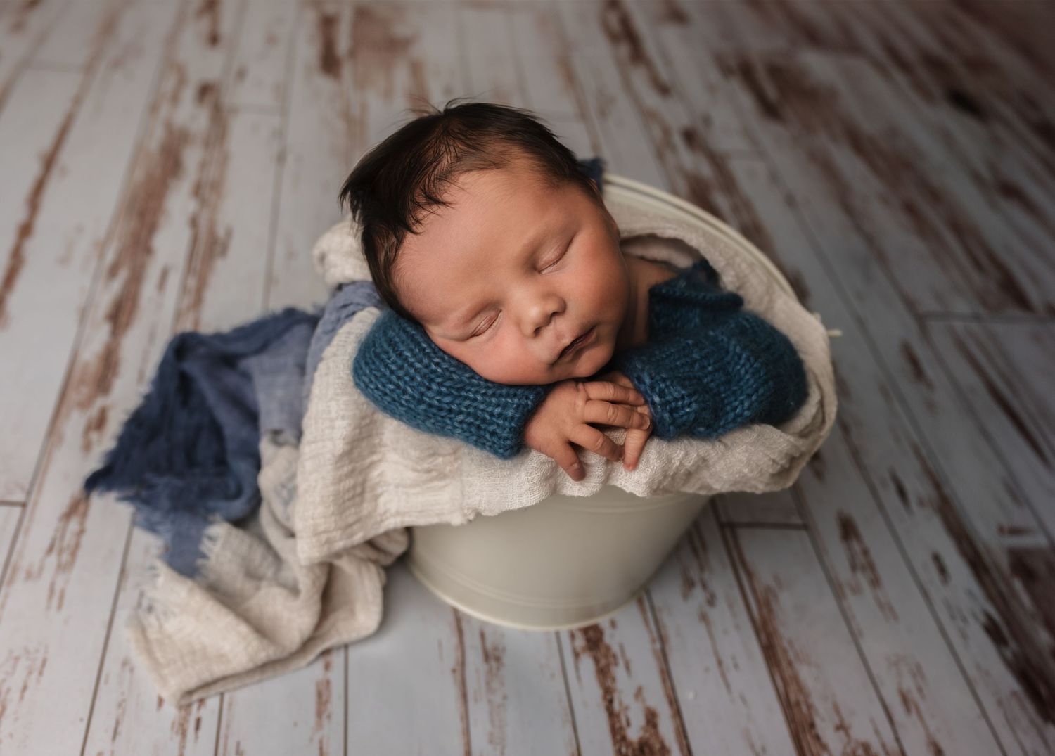 Charlottesville photographer, newborn, family, baby, maternity, baby boy in blue knit bodysuit and sleeping in white basket.