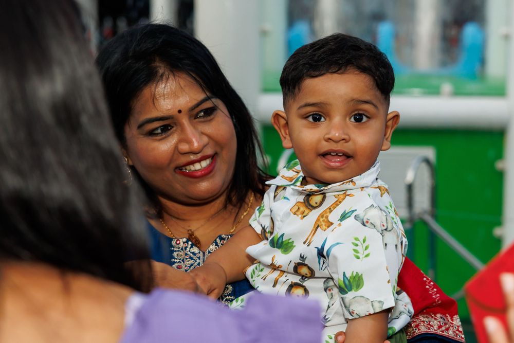 A warm moment captured during a family celebration with decorative background.