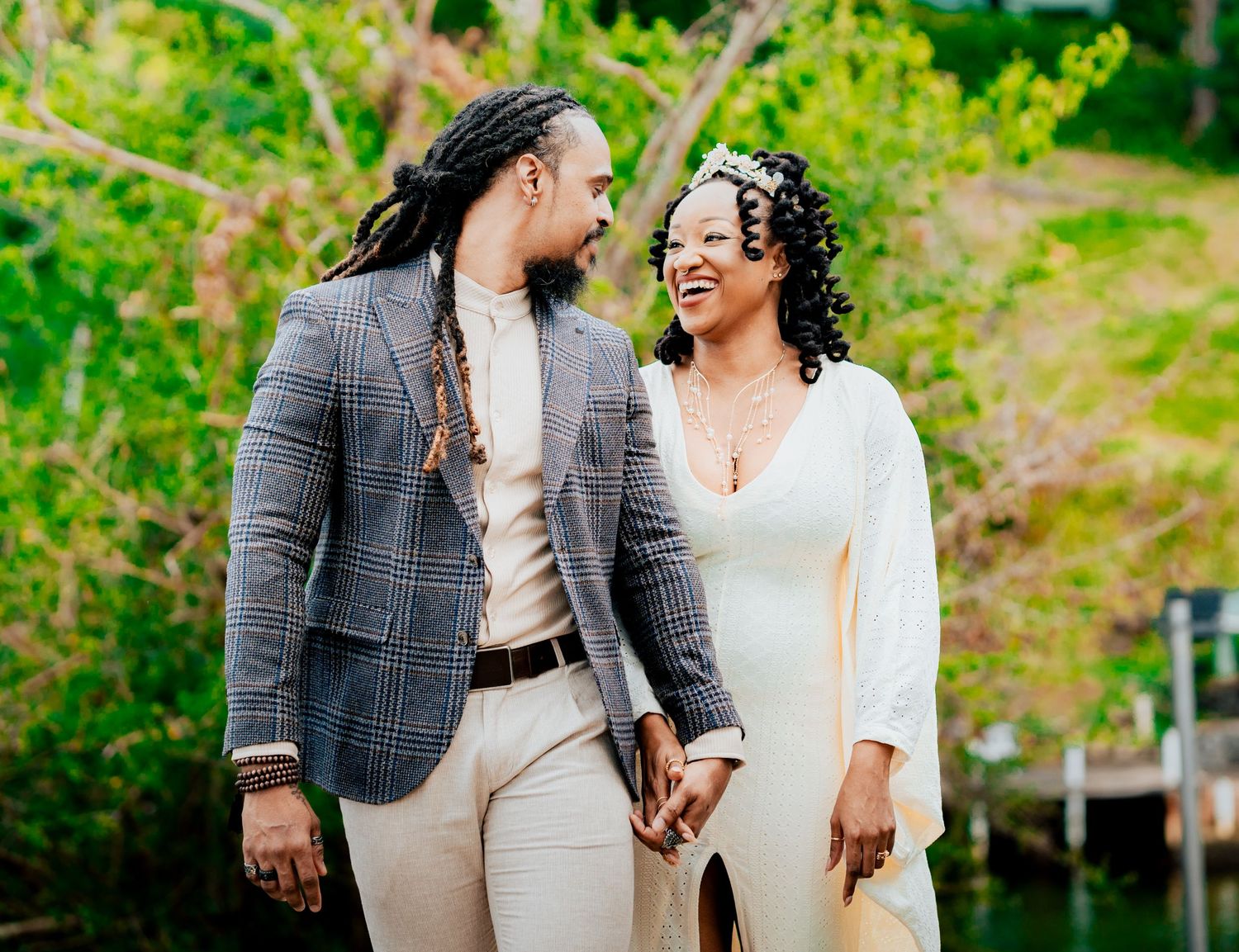 Couple enjoying a romantic moment together outdoors in a lush green garden setting.