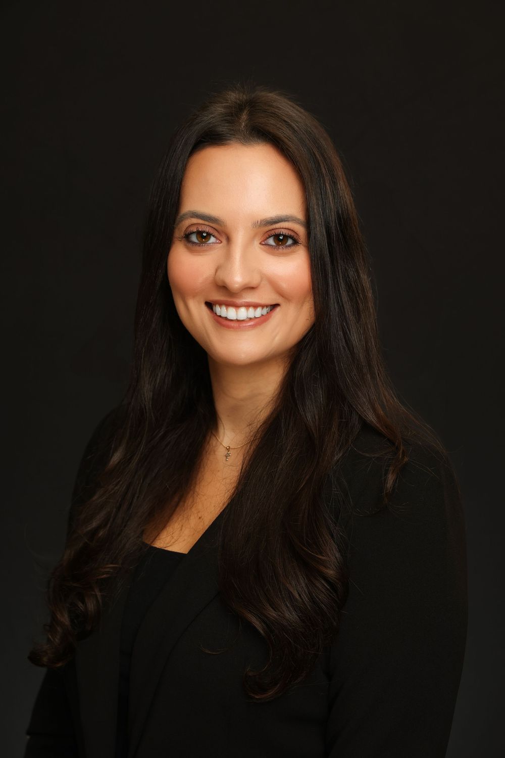 Professional headshot series against dark background showing warm smile and long dark hair in business attire.