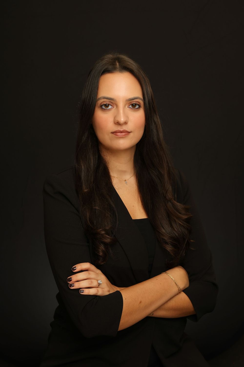 Professional portrait series against dark background featuring dramatic lighting and black attire in elegant studio setting.