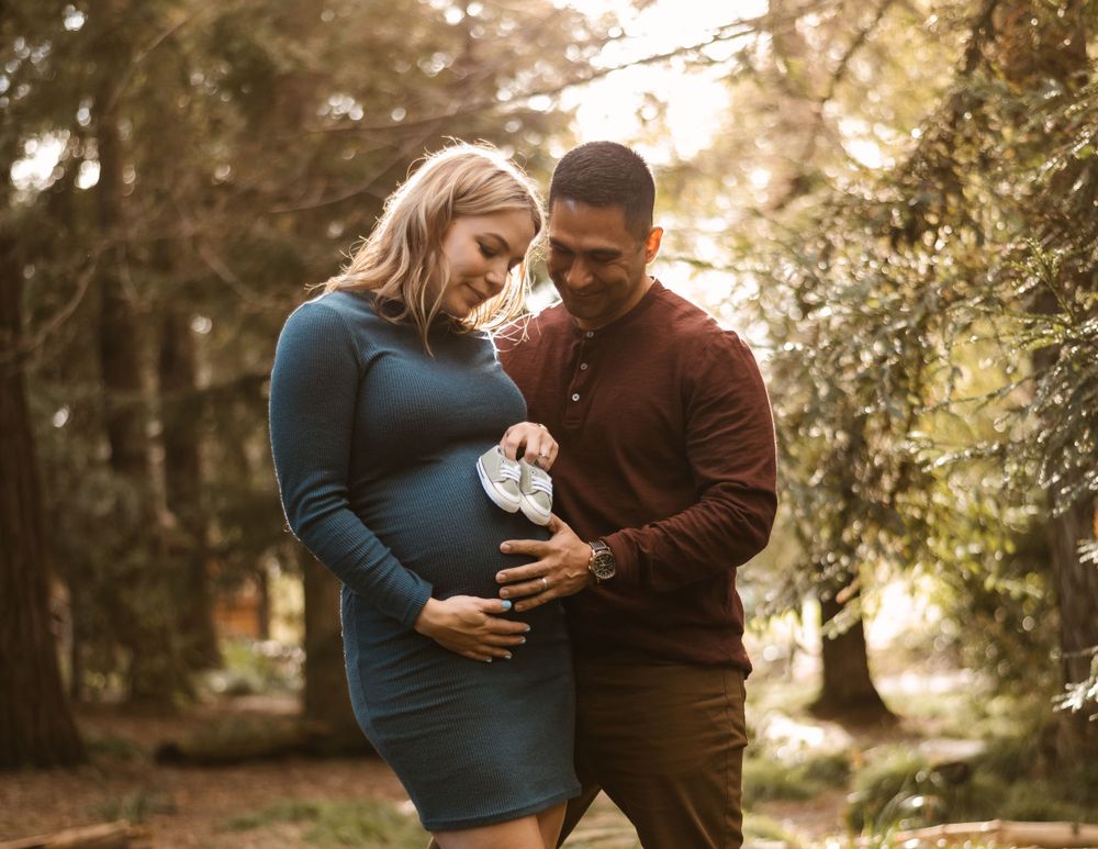 Beautiful forest maternity session with warm natural lighting.