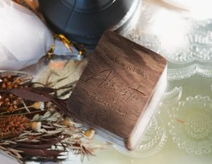 Rustic wooden box with engraved details surrounded by dried flowers and decor.