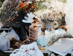 Artistic arrangement of wedding decorations with dried flowers and vintage items on display.