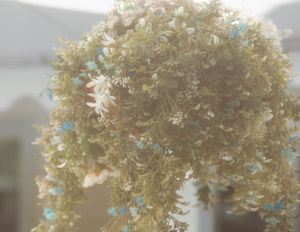 Close-up of a delicate white floral arrangement with soft lighting and dreamy bokeh effect.