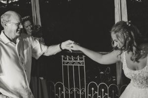A black and white photo of a dance moment at a wedding reception.