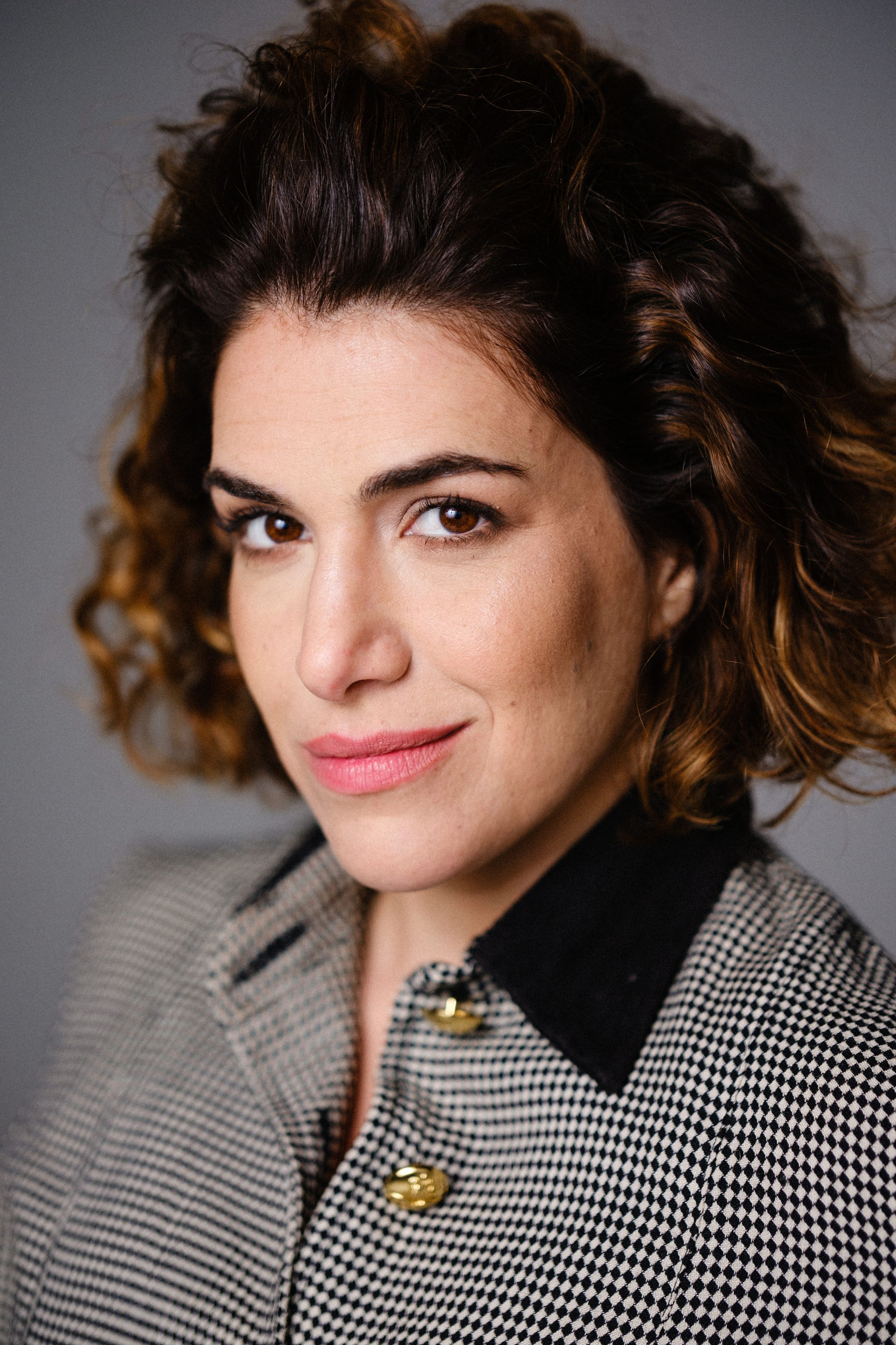 Close-up portrait showcasing houndstooth pattern jacket with black collar detail.