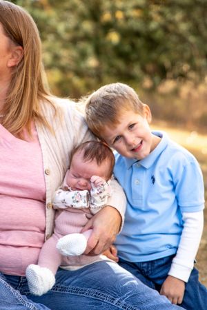 Tender family moment captured outdoors during autumn photo session.
