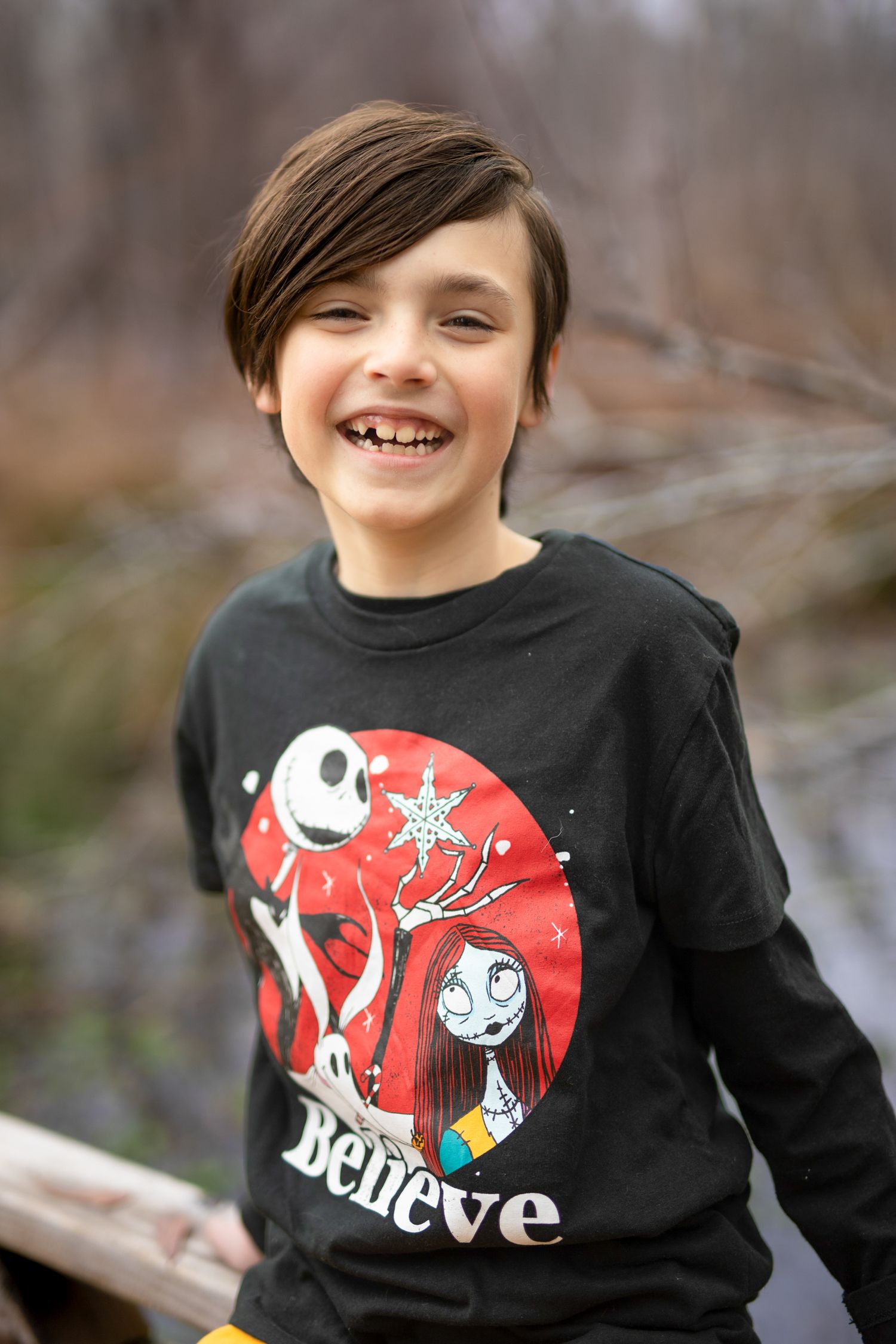 Natural light photo of smiling boy enjoying time in nature.