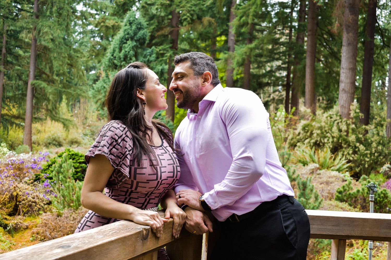 Candid Garden Kiss Engagement Shot
Playful and loving moment captured between a couple sharing a kiss in a lush botanical garden.