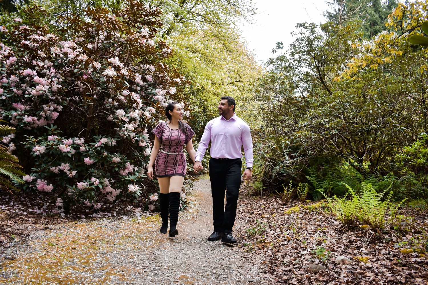 Botanical Garden Engagement Walk
Romantic photo of a couple walking hand-in-hand through a blooming garden pathway. Perfect for spring.