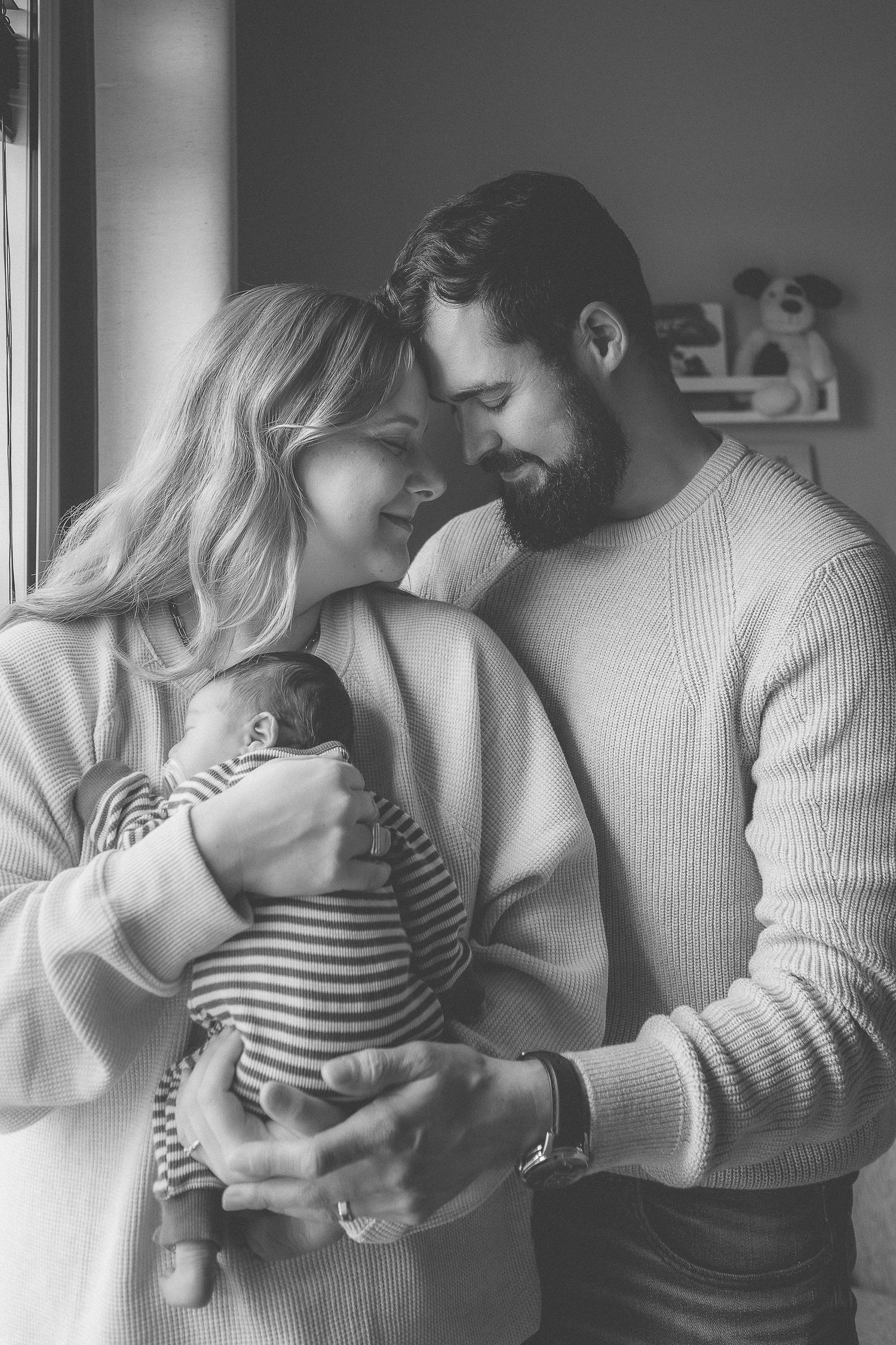 Dad is kissing newborn baby at home in Gnader