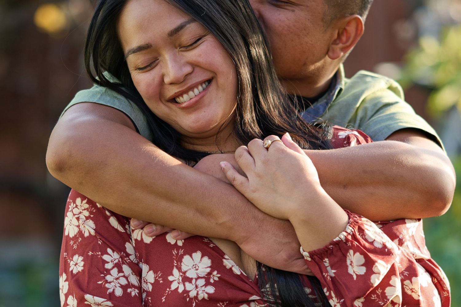 Intimate couple embracing outdoors with warm lighting and candid emotion in Weston Ranch California.