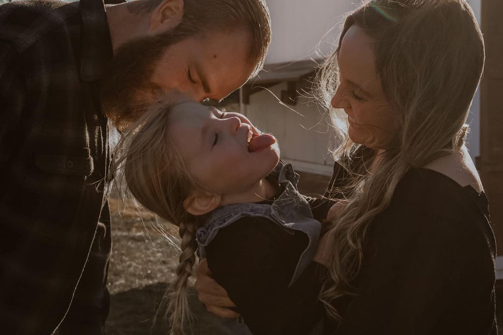 Intimate outdoor photoshoot with warm lighting and natural expressions.