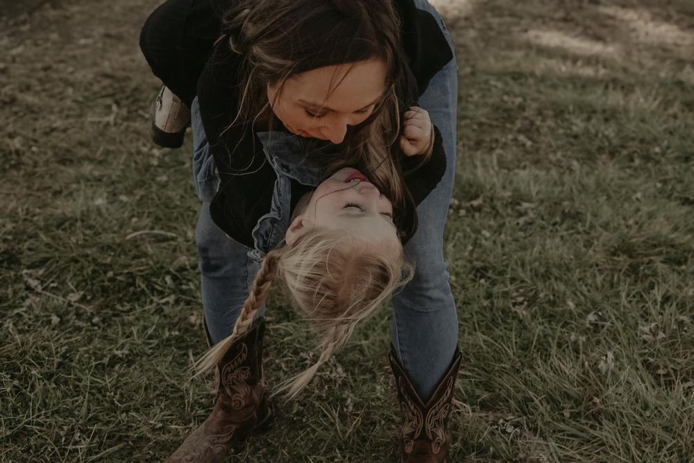 A tender moment shared between two people playing outdoors at sunset.