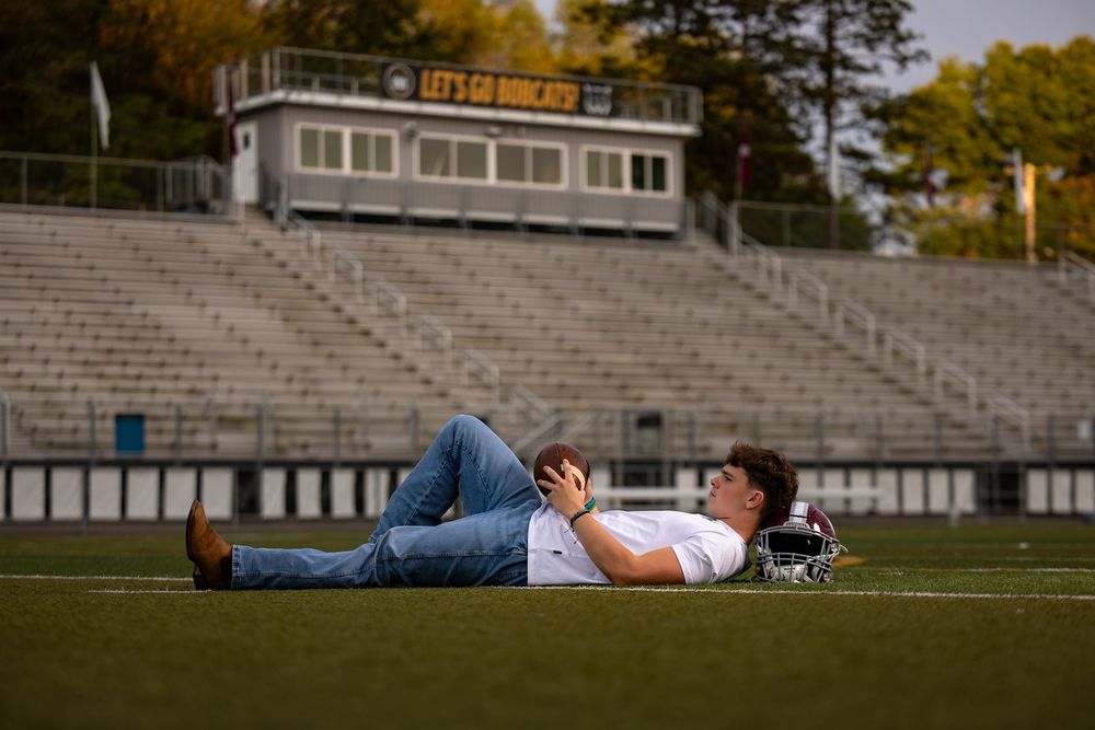 Empty stadium bleachers and field create a dramatic backdrop for an outdoor sports venue.