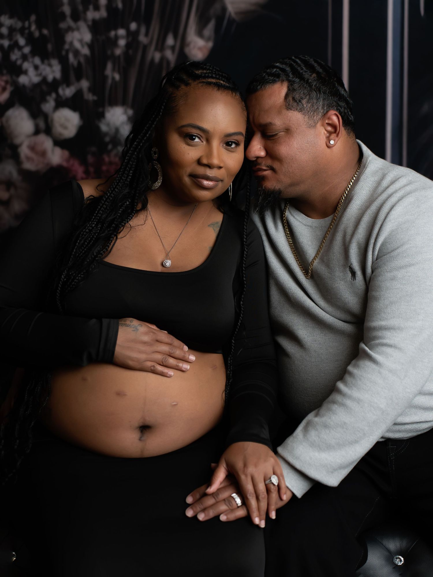 Husband affectionately holds pregnant wife.